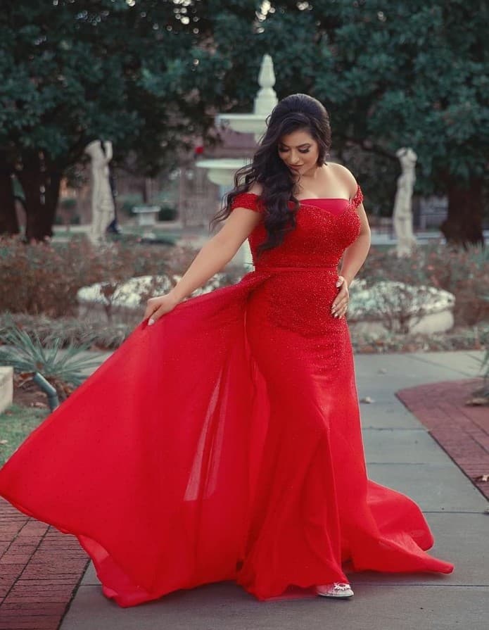 Off-the-shoulder red formal gown with glam waves styled for a special event at R&M Salon