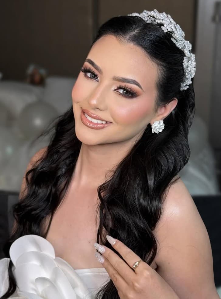 Bridal half-up hairstyle with pearl headpiece and soft waves at R&M Salon