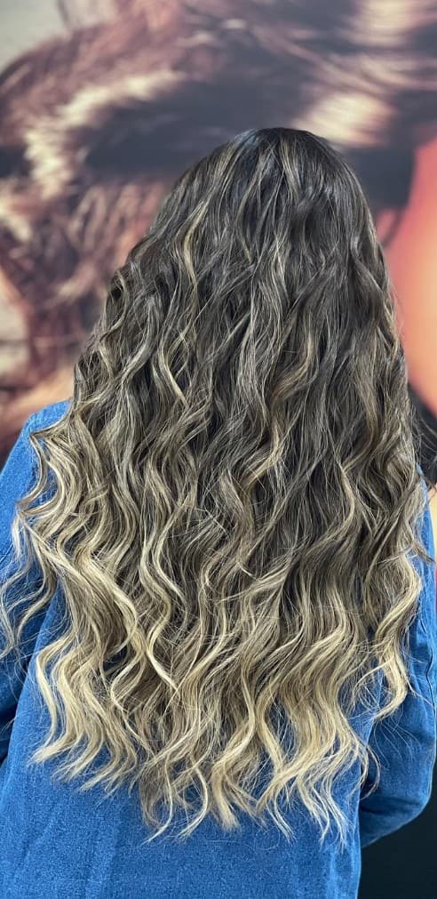 Beachy balayage waves back view showing seamless blonde color melt at R&M Salon