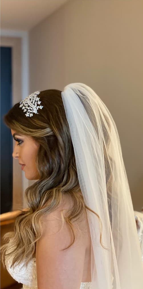 Bridal updo with crystal hairpiece and cathedral veil at R&M Salon